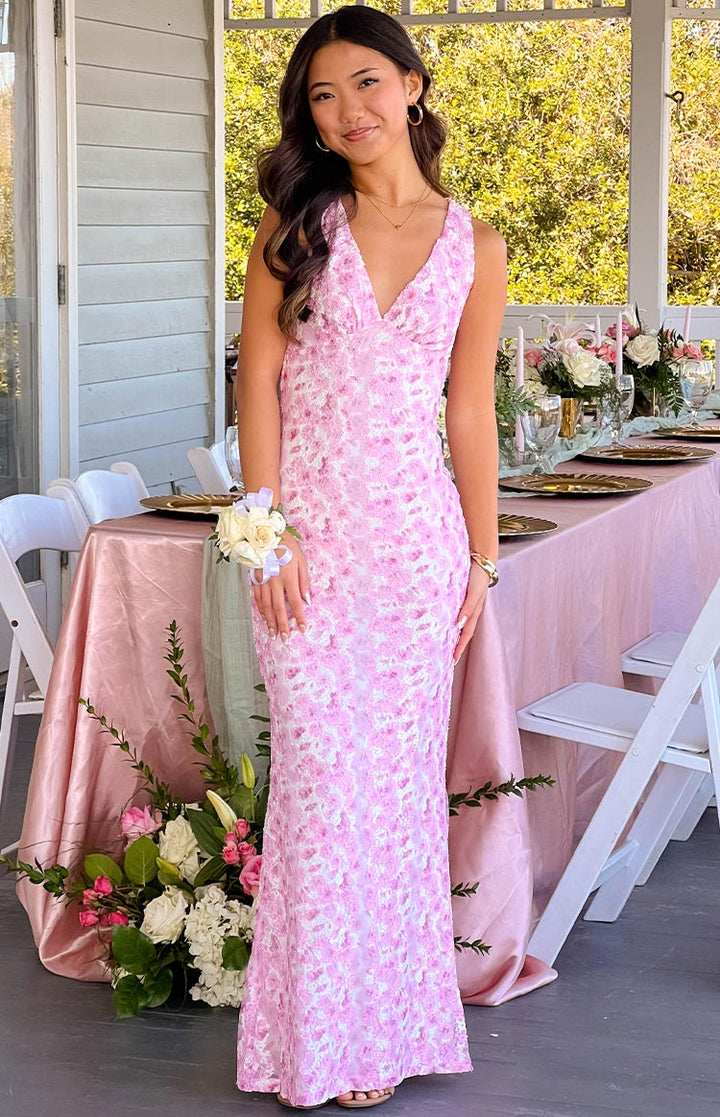 Elegant pink maxi dress in a studio setting, emphasizing its formal and sophisticated style