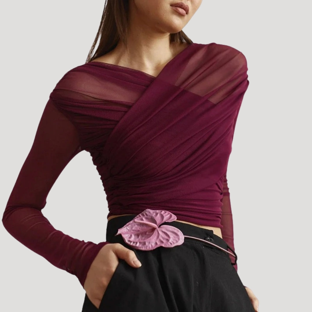 Women's sheer wrap top with long sleeves, ideal for layering in spring.