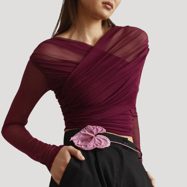 Women's sheer wrap top with long sleeves, ideal for layering in spring.