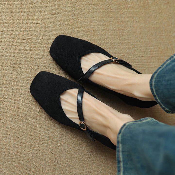 Studio shot of women's comfortable black suede block heel pumps with buckle strap.