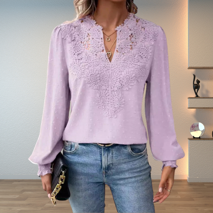 White women's lightweight blouse featuring elegant lace, v-neck, and long sleeves. Casual chic style.