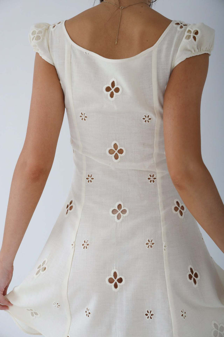 Model wearing an elegant white midi dress, perfect for weddings, guests, or evening wear.
