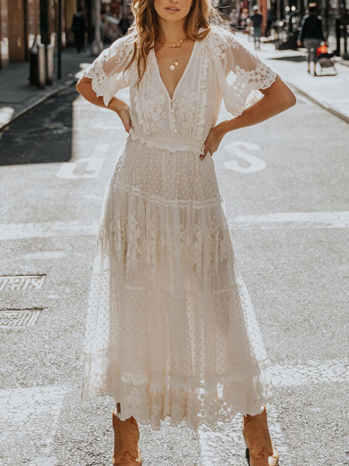 White women's short sleeve V-neck A-line midi dress, elegant flowing design, suitable for any summer event.
