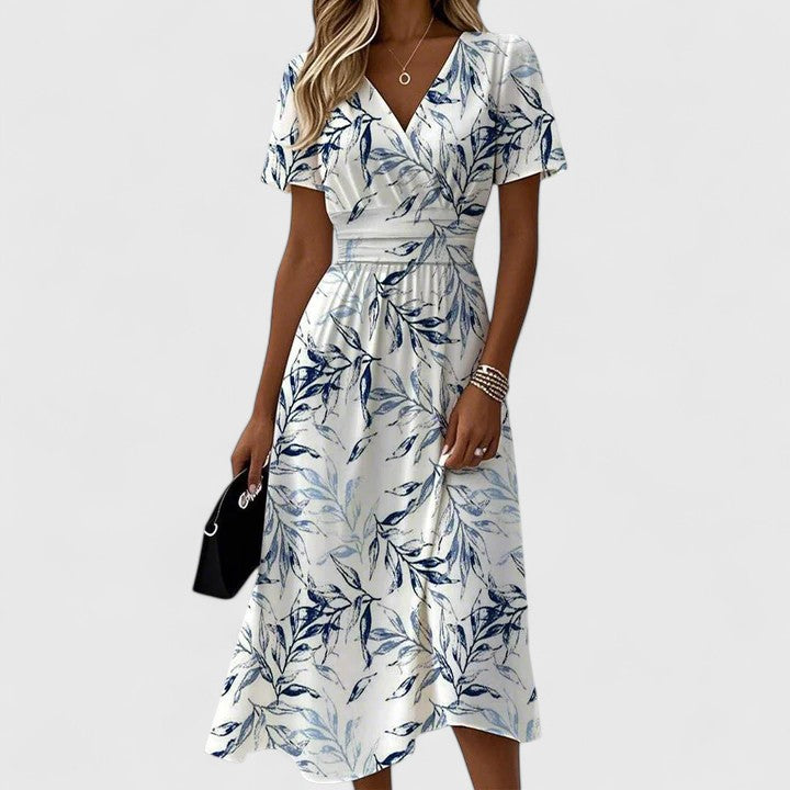 Women's timeless white flowy maxi dress. Versatile V-neck style, ideal for special occasions or elegant summer fashion.