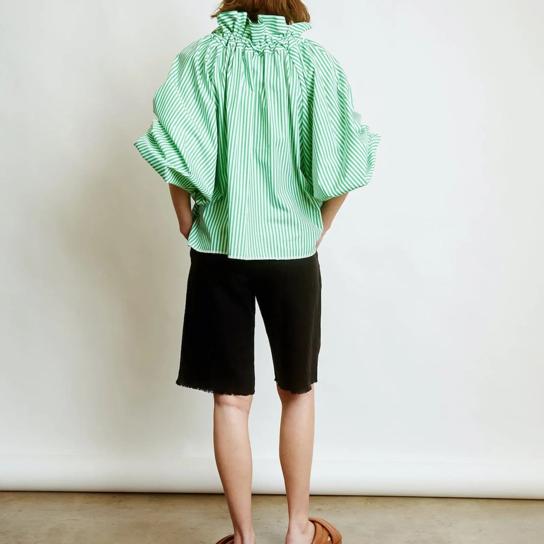 Fashion-forward women's white blouse, featuring unique puffed lantern sleeves and a delicate bow tie.