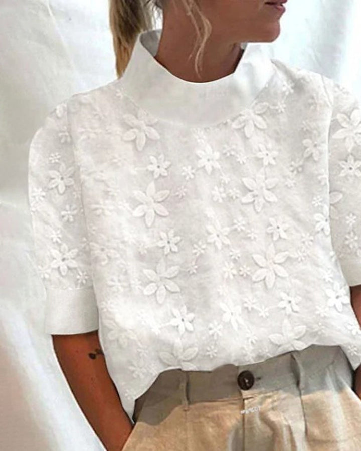 Stylish ladies white blouse with sophisticated stand collar and intricate floral embroidery, a timeless and versatile top.