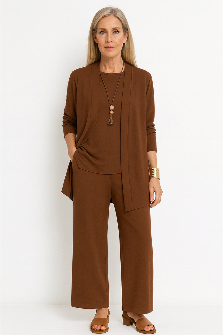 Model in elegant women's 3-piece pantsuit set. Versatile for business & smart casual.