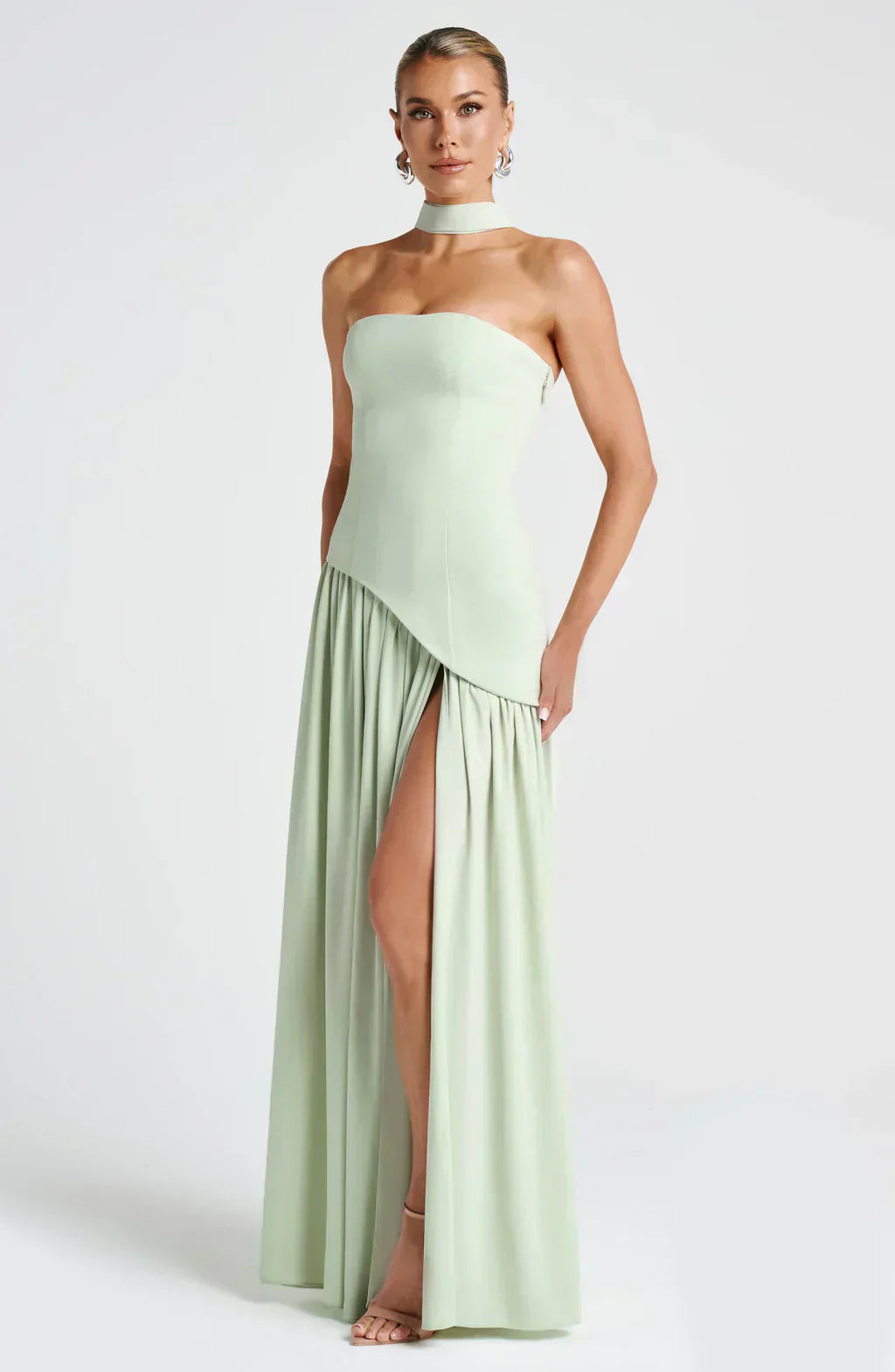 Close-up of the fabric texture on an elegant women's asymmetric maxi dress, evening wear, wedding guest.