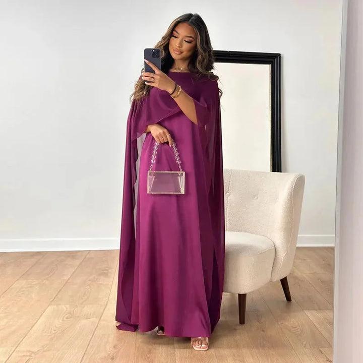 Full-length green women's cape dress, a stylish and elegant choice for wedding guests.