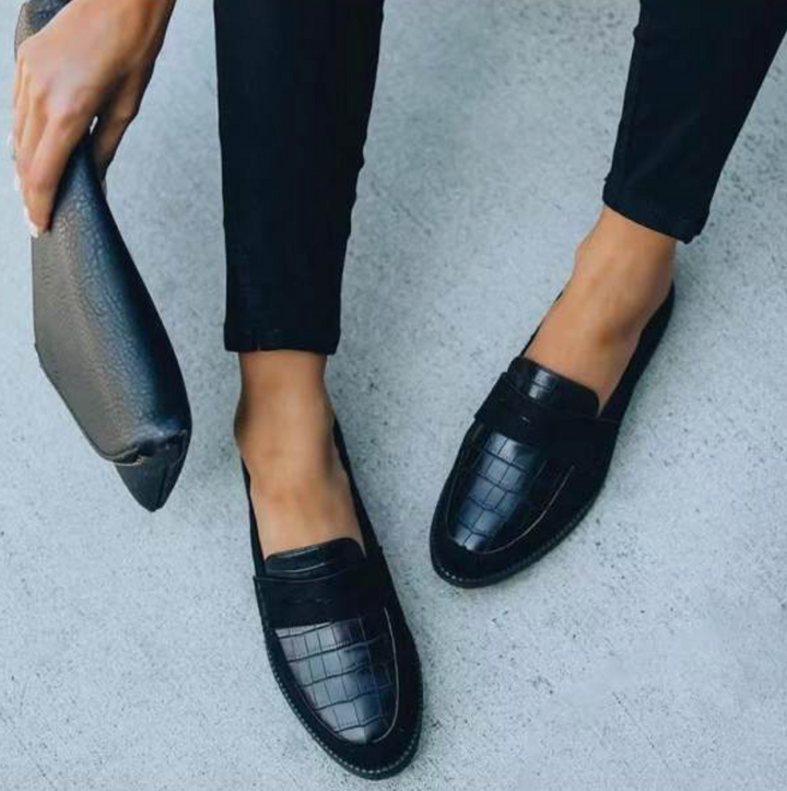 Elegant women's black croc-embossed slip-on loafers. Comfortable flat shoes for workwear & everyday fashion.