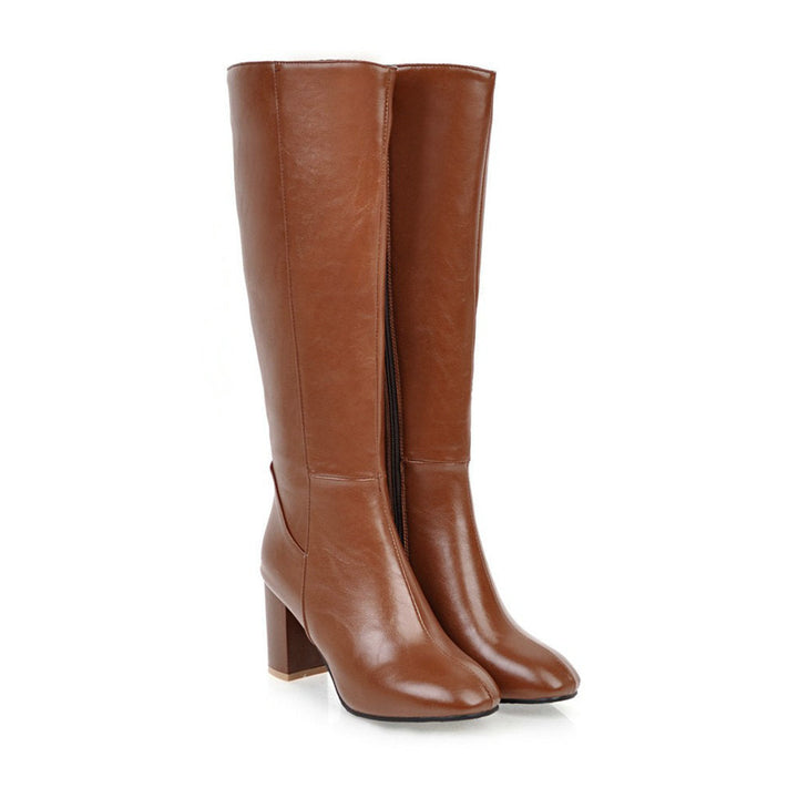 Close-up of the block heel on an elegant women's knee-high boot, showcasing quality