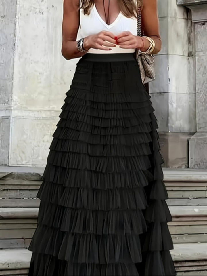 Close-up of a women's elegant tiered tulle maxi skirt in ivory, showcasing the delicate fabric, party wear fashion