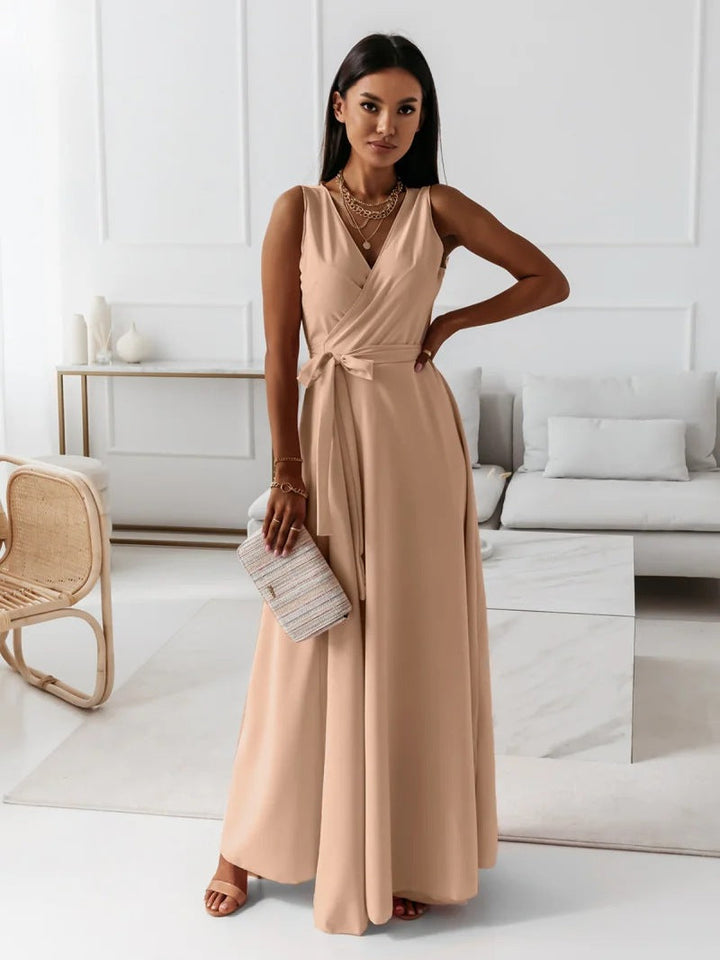 Close-up of the delicate fabric and wrap detail on a women's elegant maxi dress, suitable for wedding guests.