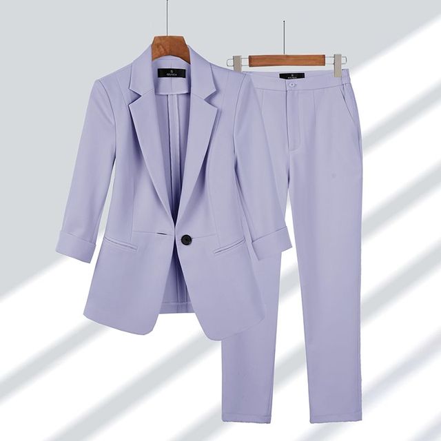 Elegant women's blazer & pants set in classic black, perfect for professional business attire & office wear. Tailored two-piece suit.