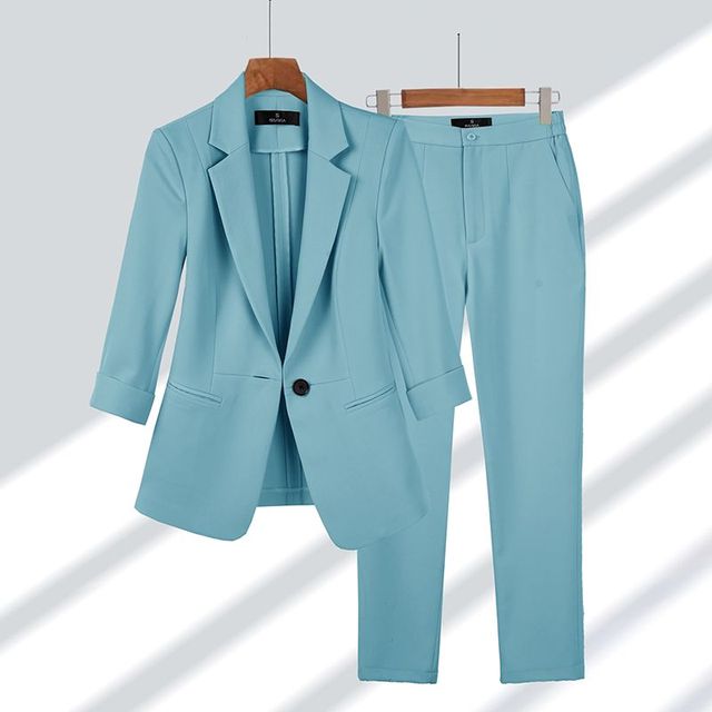 Chic women's tailored blazer and pants set for formal wear, business meetings, or elegant office fashion. Modern power suit.