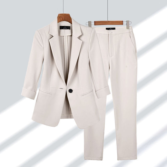 Stylish women's matching two-piece blazer and pant set, ideal for professional outfits & business events. Comfortable fit.