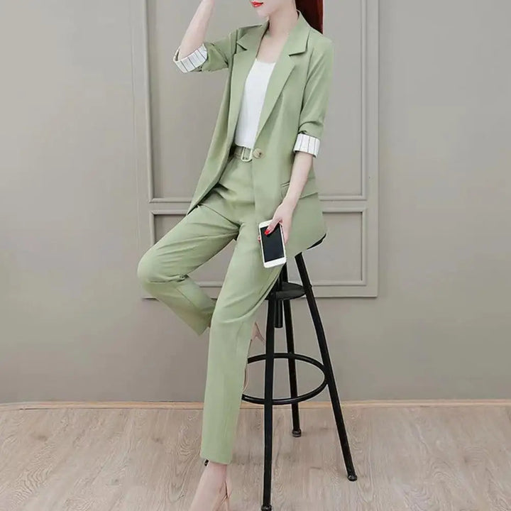 Chic women's three-piece business attire: stylish blazer, matching trousers and sleeveless top