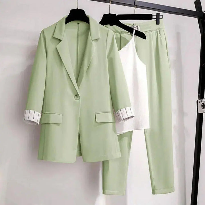 Formal women's coordinated set featuring a tailored blazer, flowing pants, and a sophisticated top