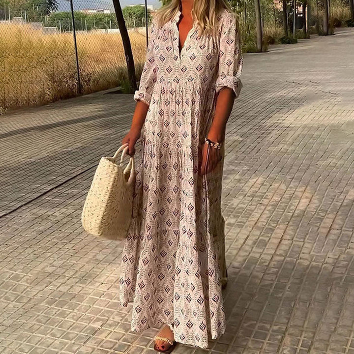 Bohemian women's maxi dress featuring a chic V-neck, flowing silhouette, and a beautiful, intricate print design.