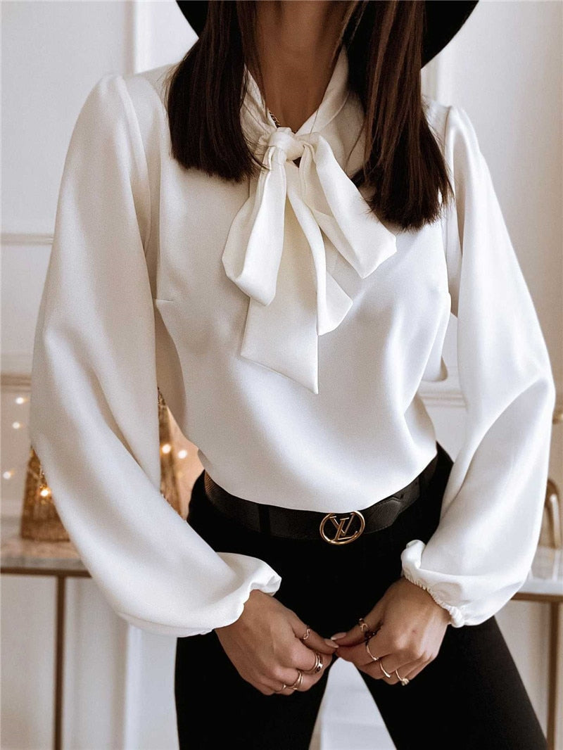 Chic and stylish women's long sleeve top featuring a delicate bow neck and puffed sleeves