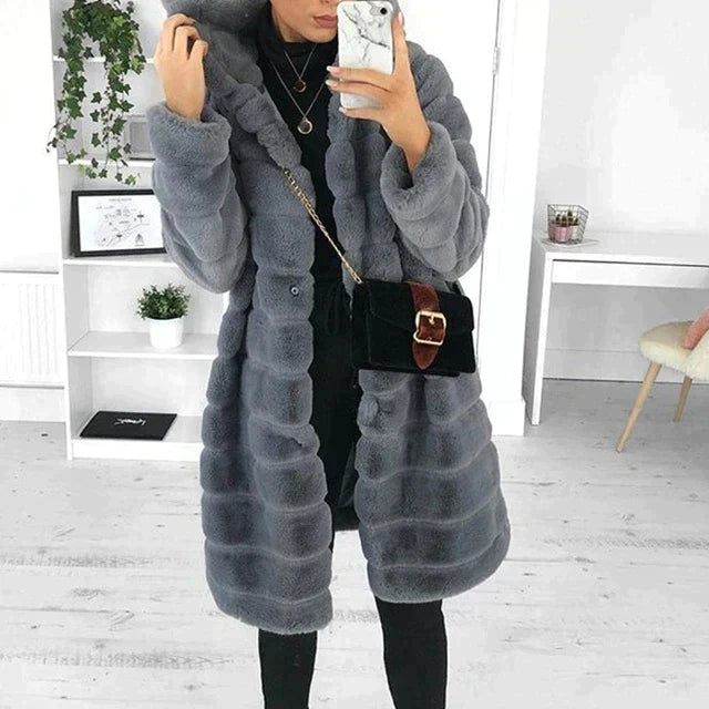 Elegant women's button-down faux fur coat in a sophisticated winter fashion, offering warmth and style.
