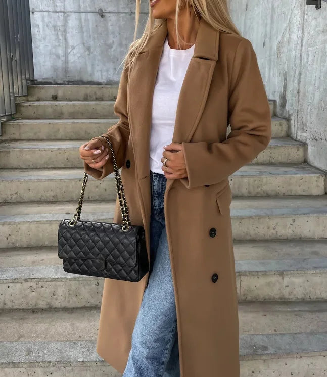 Back view of a women's classic long sleeve trench coat, featuring sophisticated outerwear details