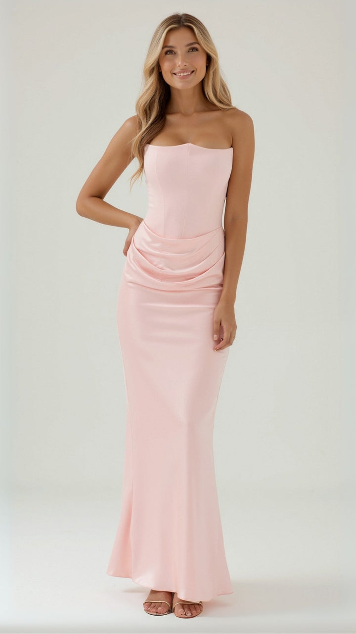 Side profile of a woman in a column maxi dress, emphasizing its flattering fit