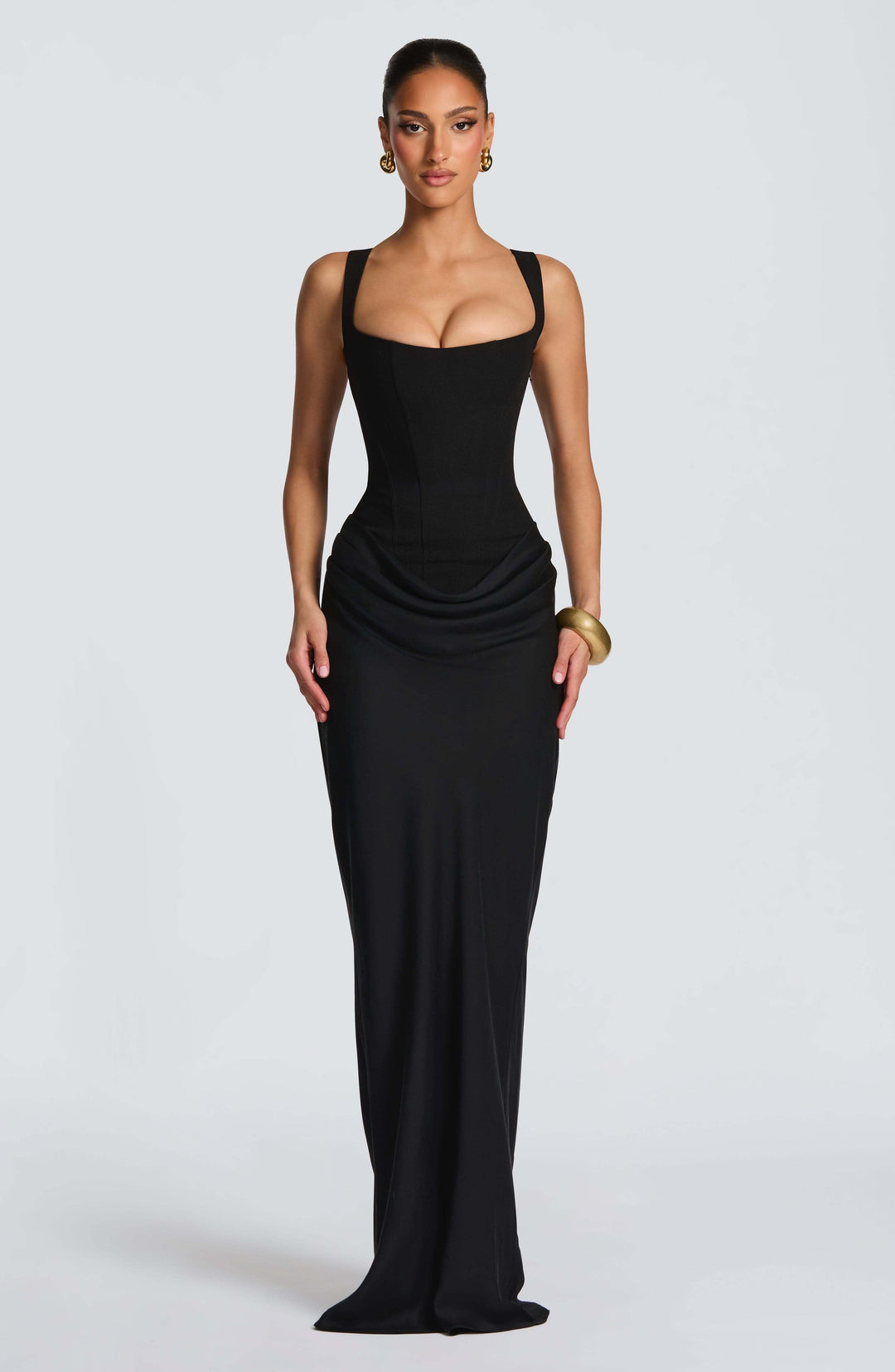 Side view of a woman in an elegant Corset Maxi Dress, showcasing its flowy skirt and flattering silhouette.