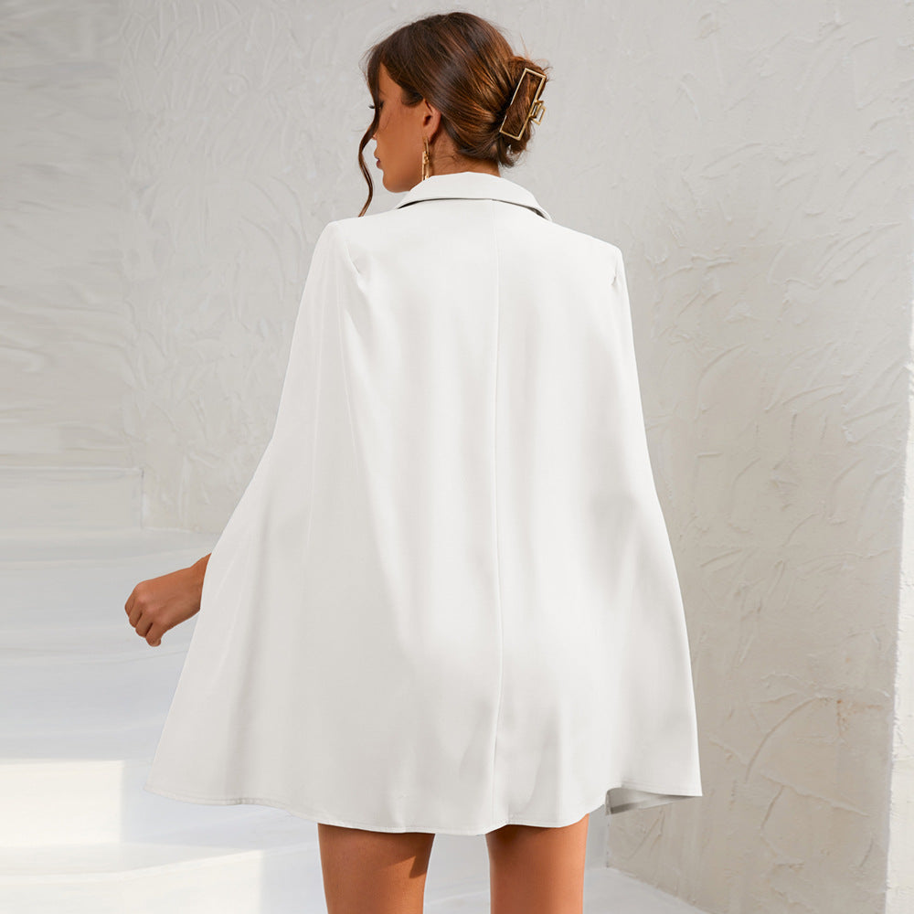 Fashionable women's double-breasted cape dress, belted for an elegant and refined silhouette.