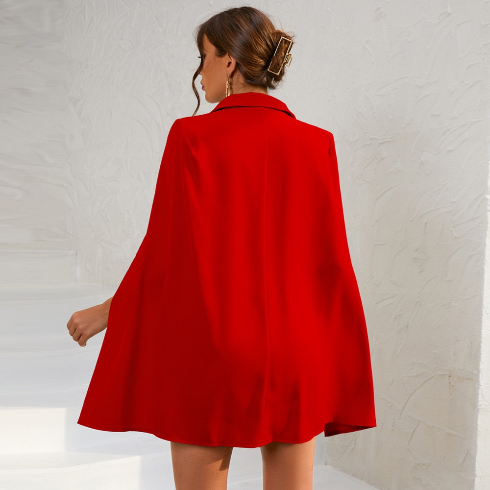 Chic double-breasted cape dress for women, featuring a prominent belt and tailored cut.