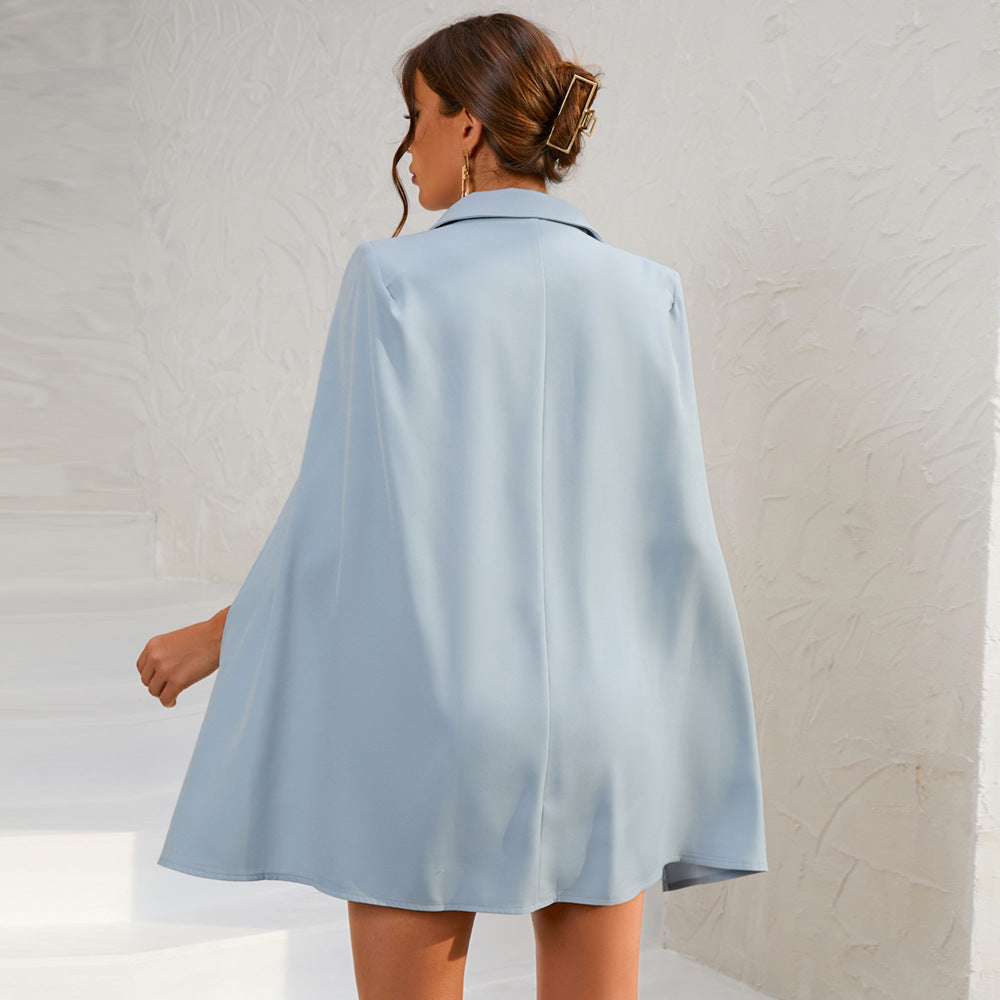 Elegant women's belted dress, double-breasted cape style suitable for formal wear.