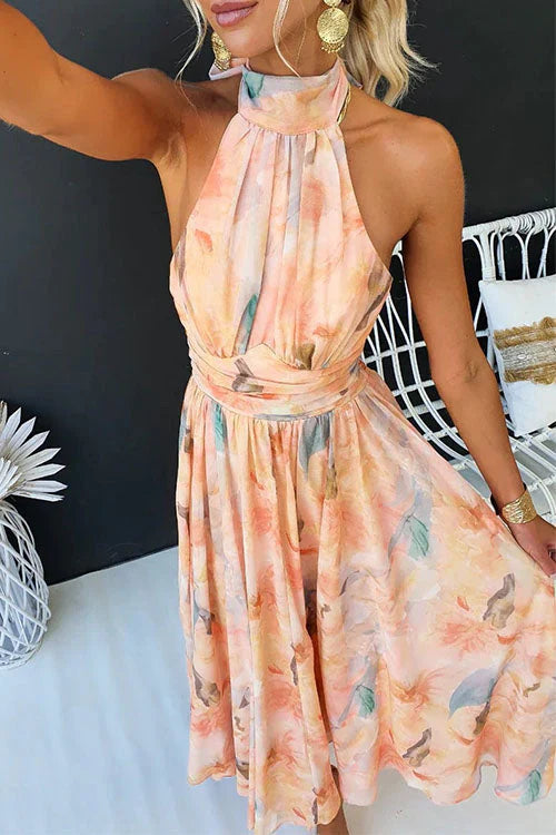 Women's elegant halter neck maxi dress featuring a vibrant floral pattern, great for summer events