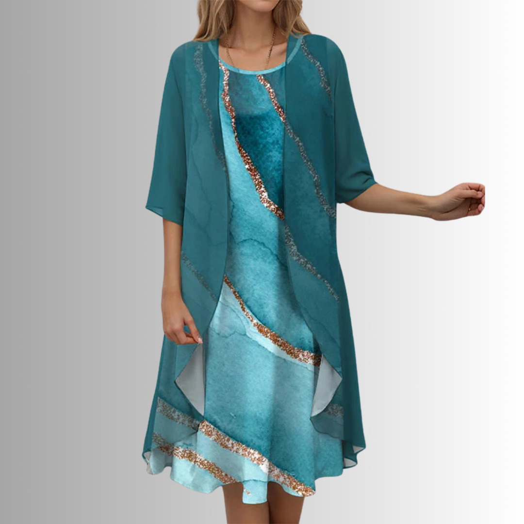 Detailed view of the beautiful floral print on the women's midi dress and matching sheer cardigan outfit.