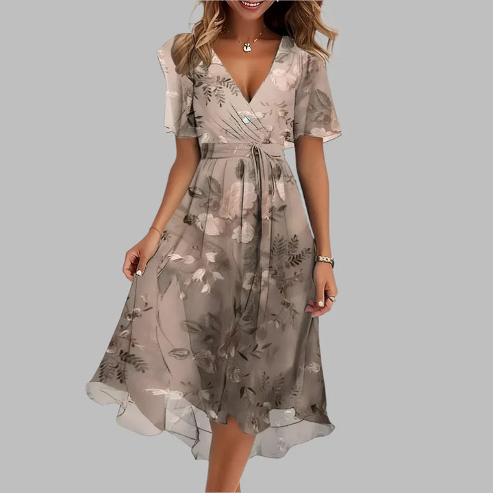Chic women's floral midi dress with ruched detailing, puff sleeves, & a flattering silhouette.