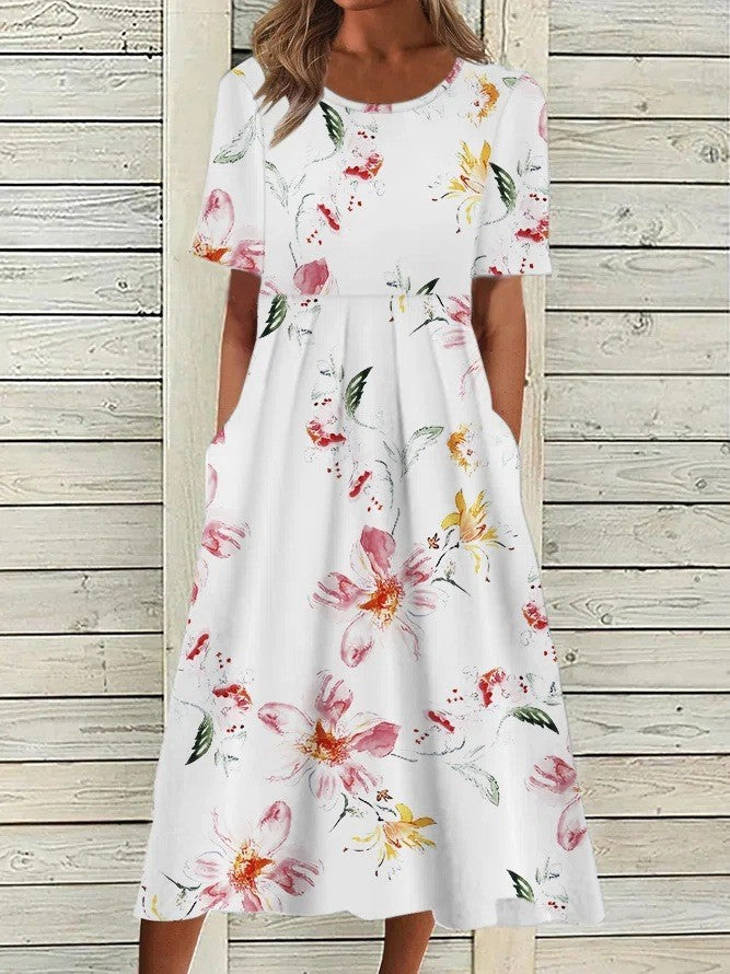 Comfortable floral midi dress for women featuring short sleeves, round neck, and pockets. Ideal elegant summer casual.