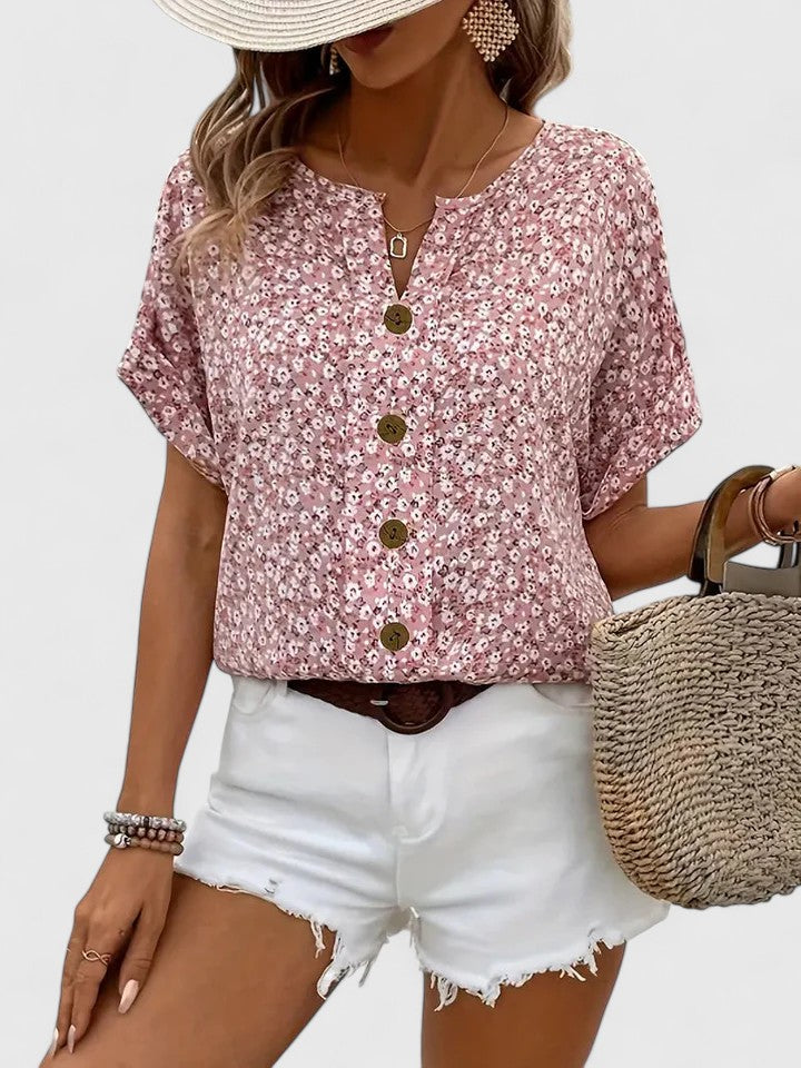 Elegant women's floral summer top with short sleeves and button detail. Perfect for casual or chic wear.