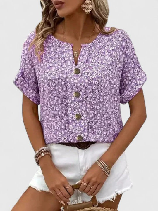 Stylish women's floral summer top, featuring a vibrant print and elegant design for a refined look.