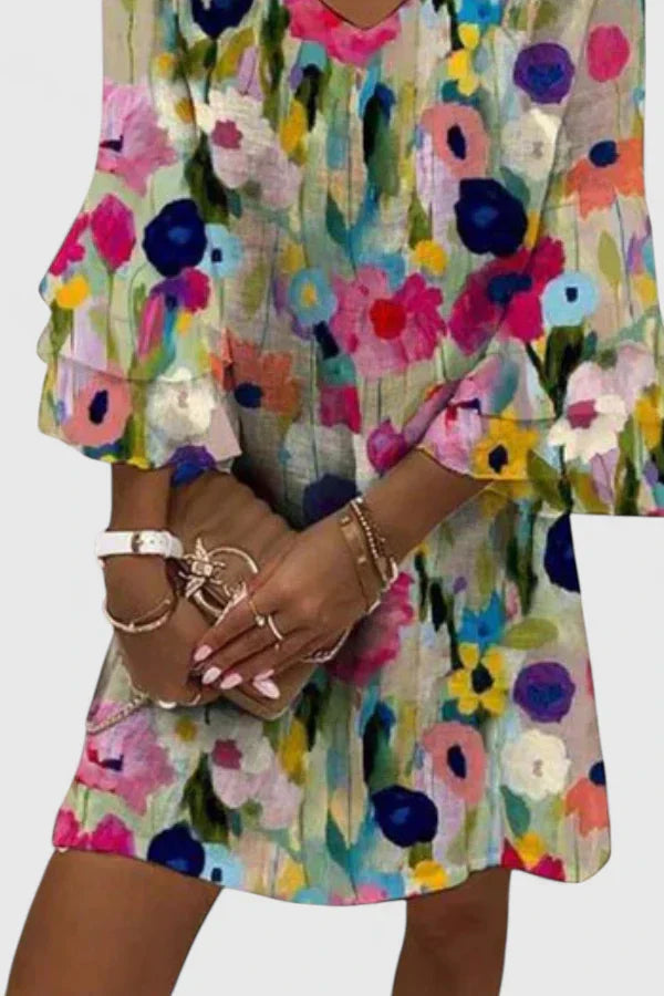 Chic women's V-neck mini dress with a vibrant floral print. Ideal for elegant events & summer fashion.