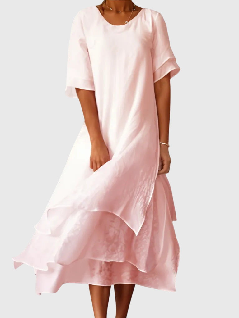 Elegant women's flowy summer dress in a vibrant color, perfect for casual outings or a stylish party.