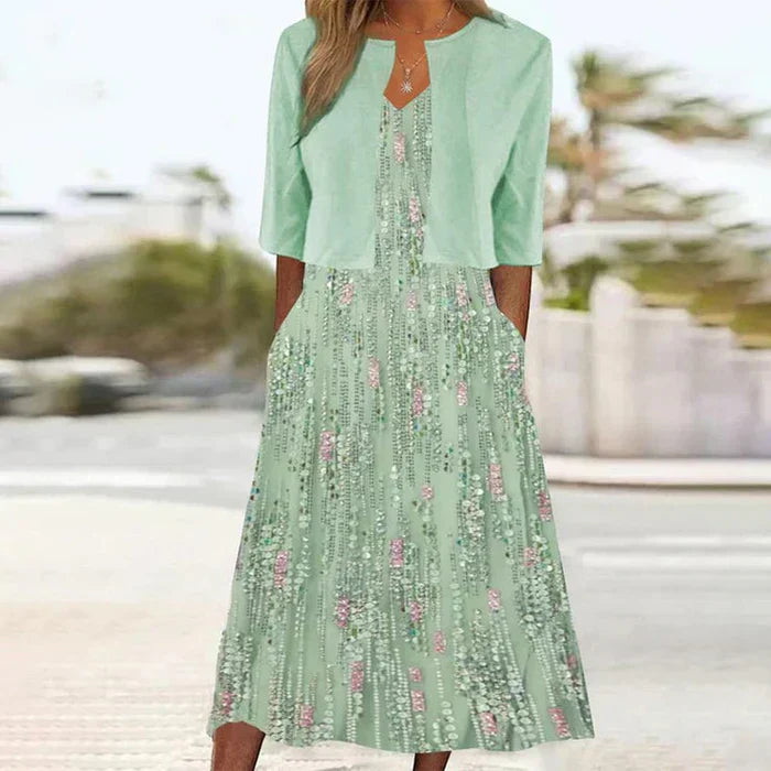 Elegant women's green floral A-line midi dress with matching cropped jacket, perfect two-piece set for occasions.