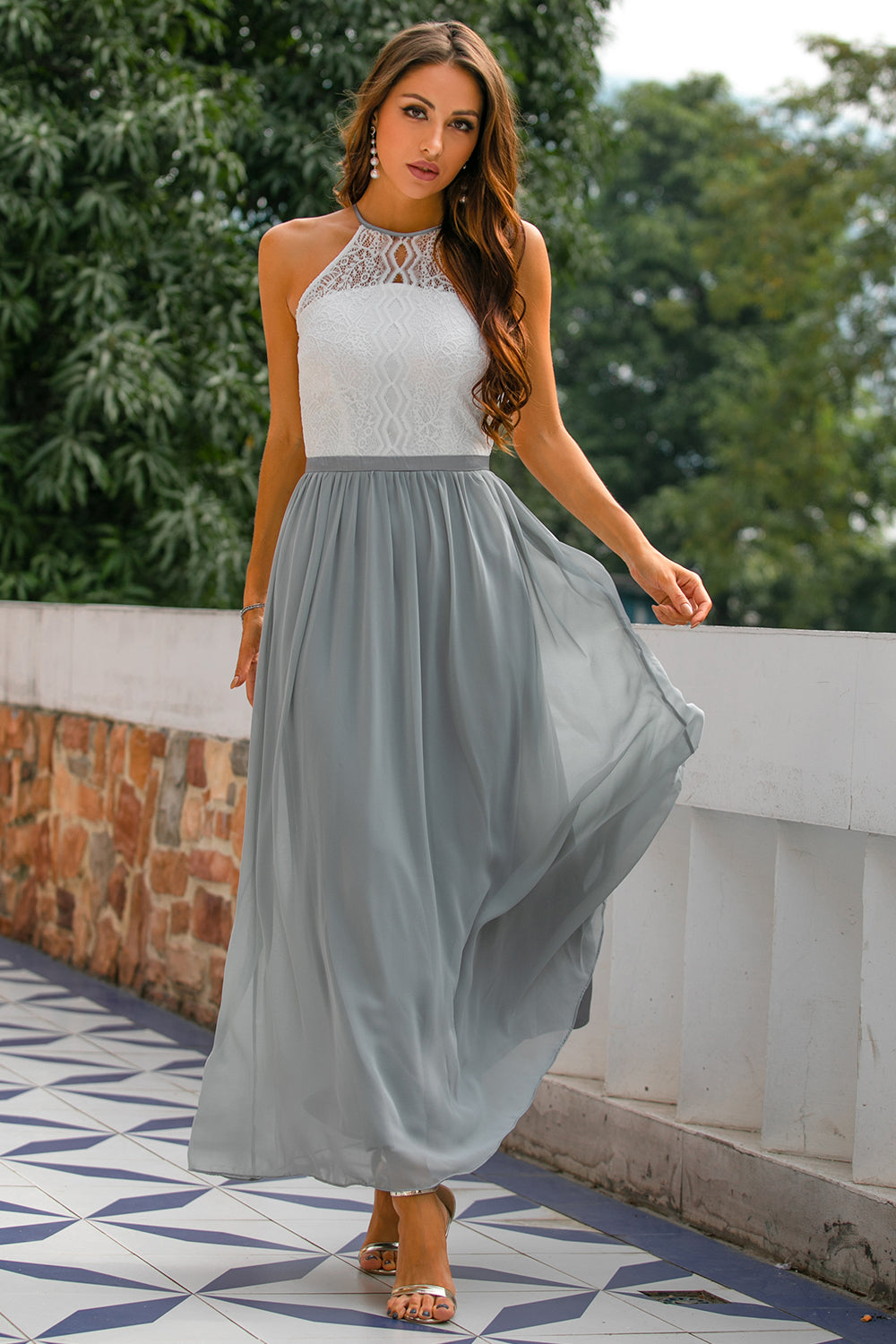 Elegant women's halter neck maxi dress in a flowing fabric, perfect for a wedding guest or formal event.