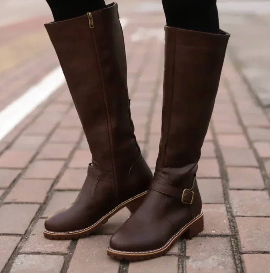 Close-up of the luxurious leather texture on women's knee-high boots, ideal for fall