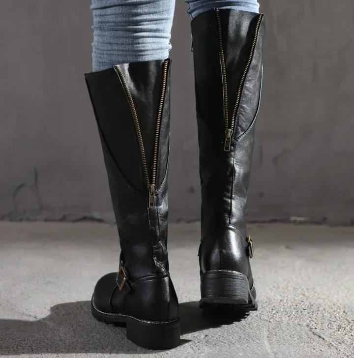 Pair of black knee-high leather boots for women, showcasing their chic and stylish appeal