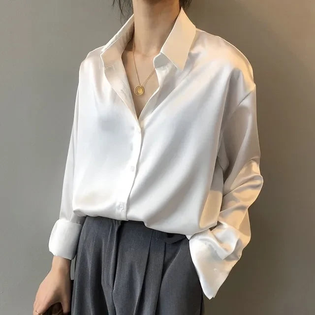 Chic white long sleeve button-down blouse for women. Elegant fashion top, perfect for office & versatile styling.