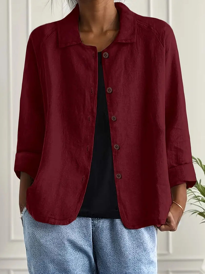 Back view of a women's elegant long sleeve button-up blouse, highlighting its clean lines and sophisticated cut.