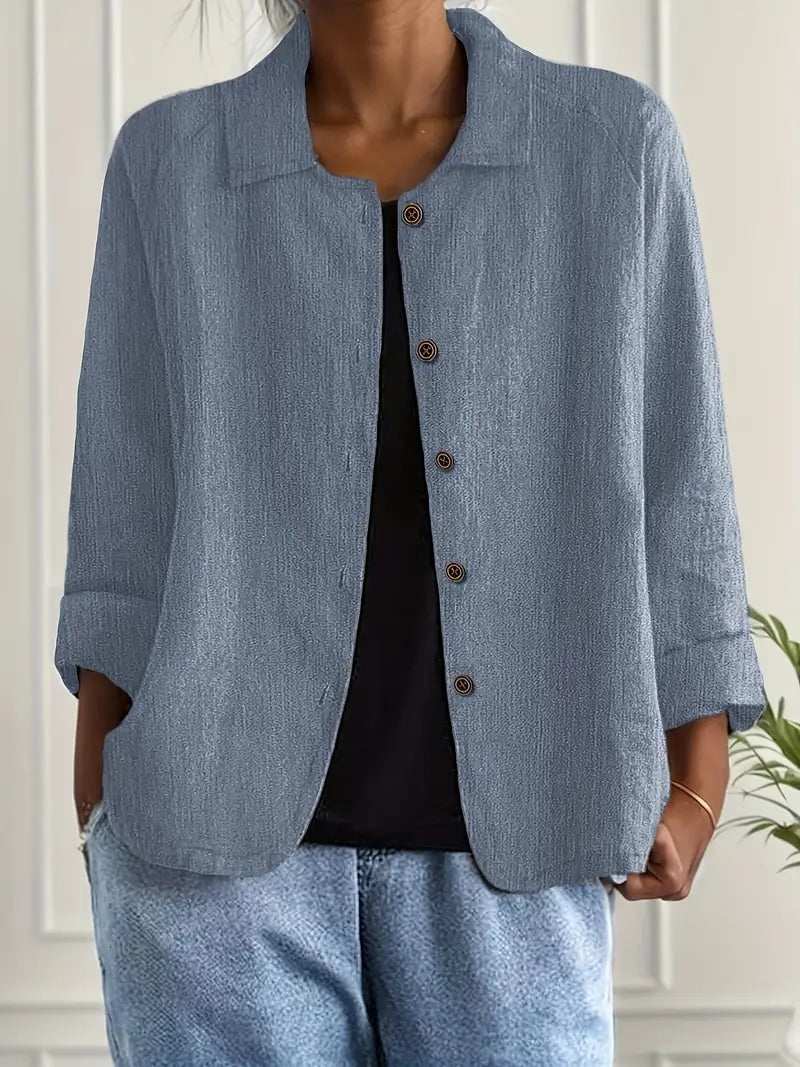 Close-up of the delicate buttons on a women's elegant long sleeve blouse, a versatile office wear option.