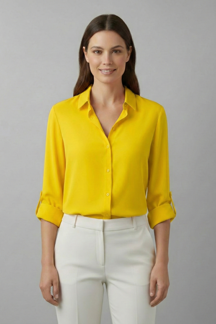 Modern women's long sleeve button-up blouse. Chic collared top for a stylish and professional look.