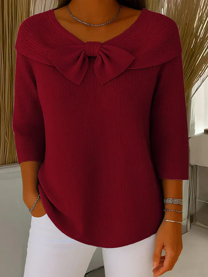 Chic and elegant women's sweater featuring a charming bow detail for versatile fall/winter styling.