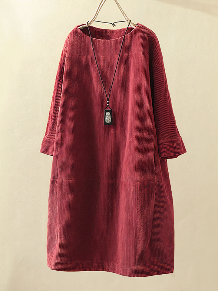 Stylish women's long sleeve midi dress featuring a rounded neck & practical pockets. Comfortable & elegant.