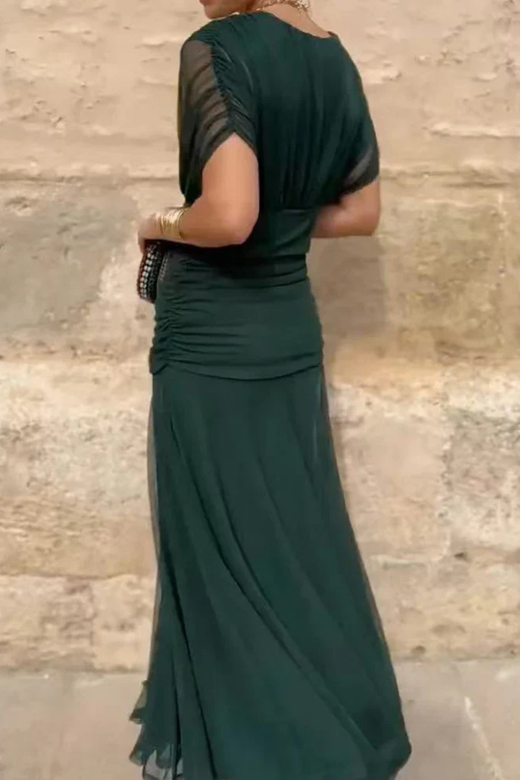 Side profile of the women's off-shoulder ruched midi dress, highlighting its flattering and flowy design.